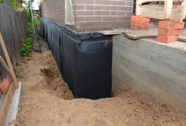 SJ Waterproofing Pros technician performing targeted Exterior Waterproofing assessment in McDonough, GA